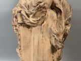 statue of a woman sitting on a pedestal with her head resting on her hands
