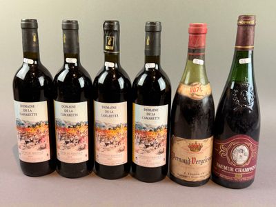 several bottles of wine are lined up on a table