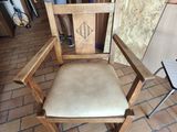 a wooden chair that is sitting on a brick floor