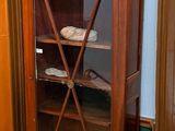 a wooden cabinet with a glass door in a room