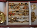 a box with a variety of rings and jewelry inside of it