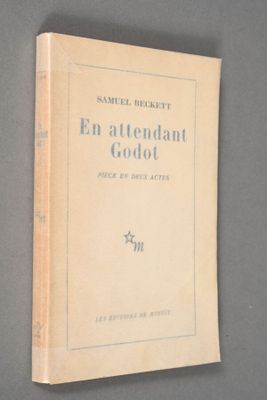an old book sitting on top of a table next to a wall
