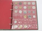 a red book with a bunch of coins inside of it