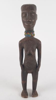 an image of a wooden statue of a person with a beaded neck