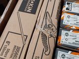 a cardboard box with a bunch of scissors in it