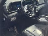 the interior of a car with a cow grazing in the field in the background
