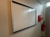 a white board on the wall in a room