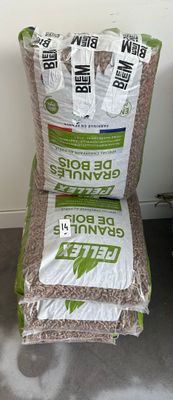 two bags of rice sitting next to each other on the floor