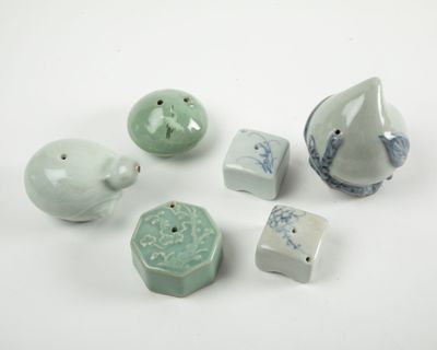 cinq pièces de poterie posées sur une surface blanche