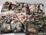 un tas de vêtements de camouflage posé sur une table blanche