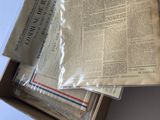 newspapers are stacked on top of each other on a table