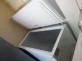 an image of a small white refrigerator in a kitchen