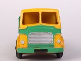 a green and yellow toy bus on a white surface