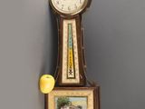 a clock that is hanging on the wall next to a television
