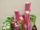 many rolls of candy in a cardboard box on the floor
