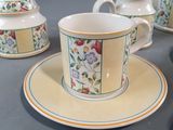 four cups and saucers on a table with a saucer