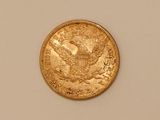 an image of a gold coin on a white surface