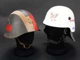 two helmets with red and white designs on them sitting on a black surface