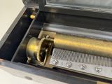 a musical box that has a clock inside of it