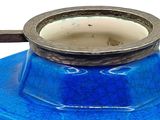an image of a blue vase with a metal handle
