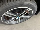 tire of a bmw car with a sticker on the rim
