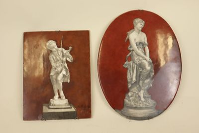 two plaques on the wall of a room with a statue on it