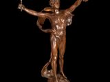 an image of a bronze statue of a man holding a wreath