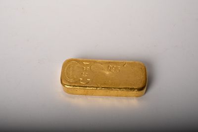 an image of a gold bar on a white surface