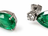 a pair of emerald and diamond earrings on a white background