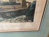 framed picture of a painting of a village with a man on a horse