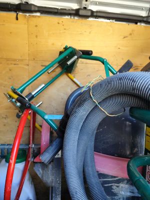 a pile of hoses and other tools in a garage