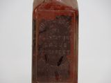 a bottle with a label on it sitting on a table
