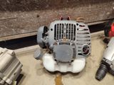 a small blower sitting on the floor next to other blowers