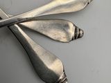 two spoons and a fork laying on a table