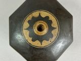 a black and gold vase with a flower design on it