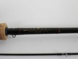 a close up of a fishing rod on a white surface