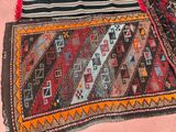 two rugs that are on a pink surface