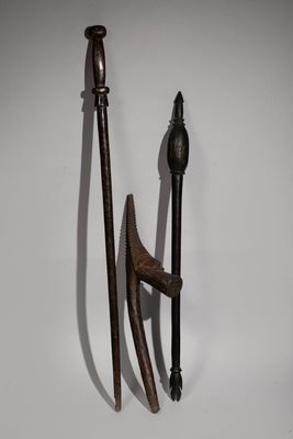 pair of old wooden and metal tools on a white surface