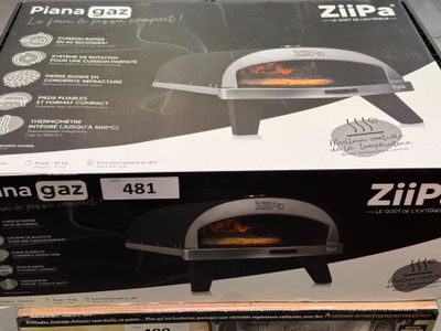 packaging of a pizza oven sitting on top of a cardboard box