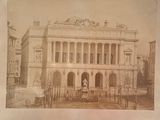 an old photo of a building with a statue in front of it