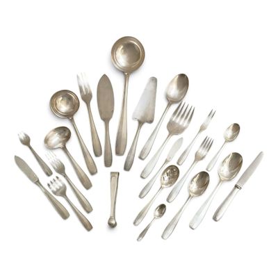 a lot of silver spoons and silverware on a white surface