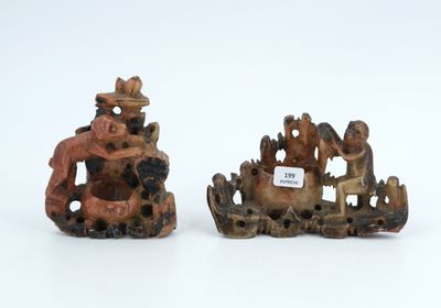 pair of chinese carved figurines of a man and a woman on a boat