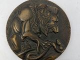 an image of a bronze coin with a lion on it ' s back