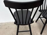 two black chairs sitting next to each other on the floor