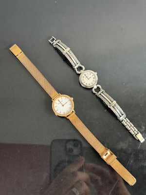 two watches that are sitting next to each other on a table