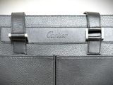 the back of a black leather purse with two metal handles