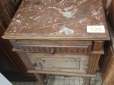 a wooden table with a marble top in the corner of a room