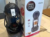 a box of coffee on a table next to a coffee maker