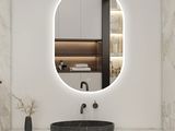 a bathroom with a sink and a mirror in it