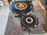 two tables and two chairs in a room with a rug